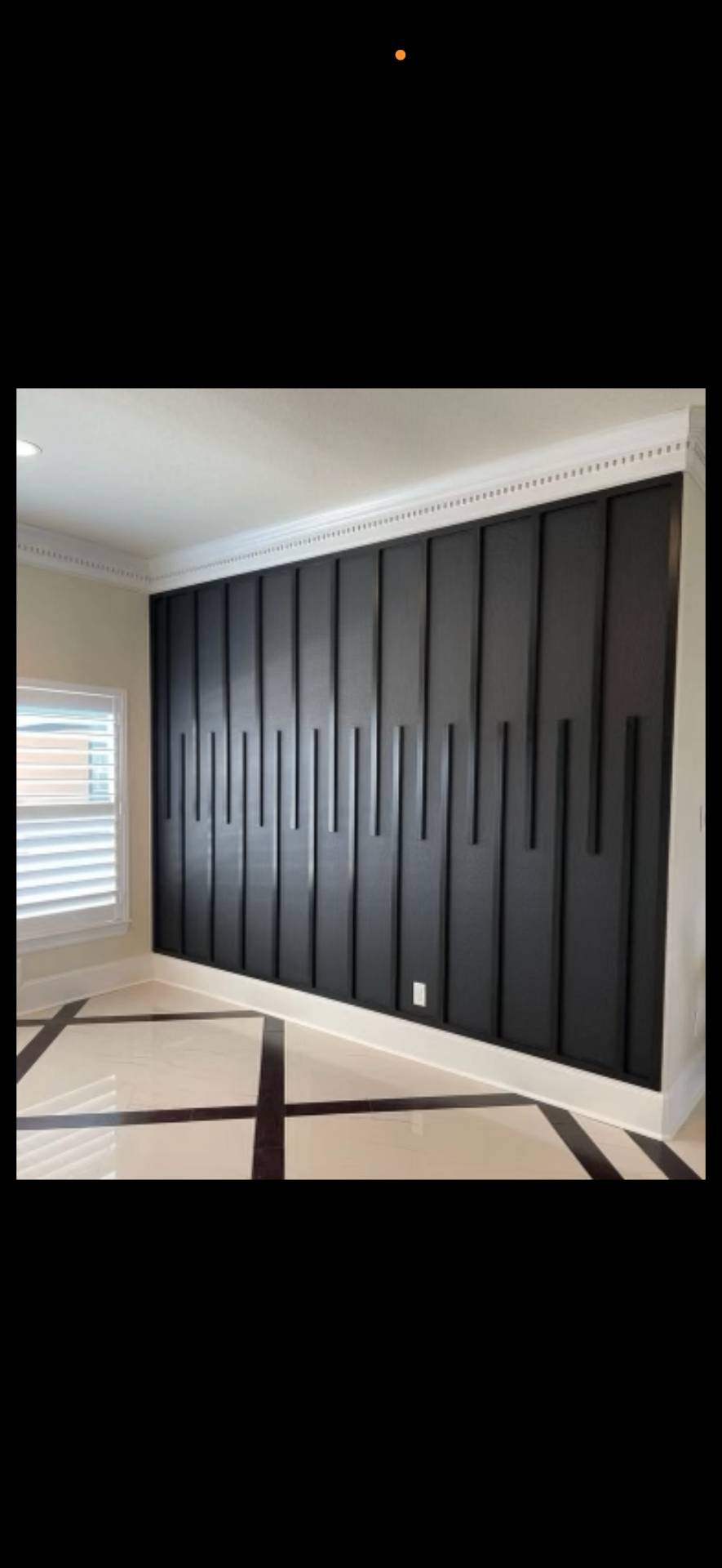 Custom black slatted accent wall, sprayed and finished on site